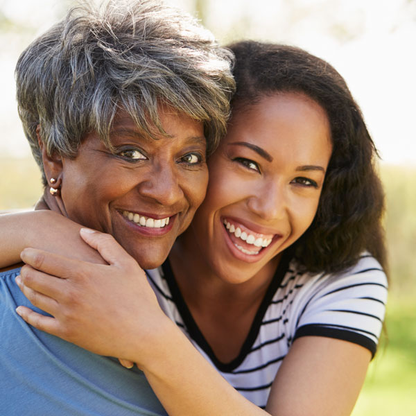 mature mom and daughter smiling