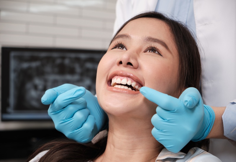 Smiling patient after dental implants in Livonia, MI