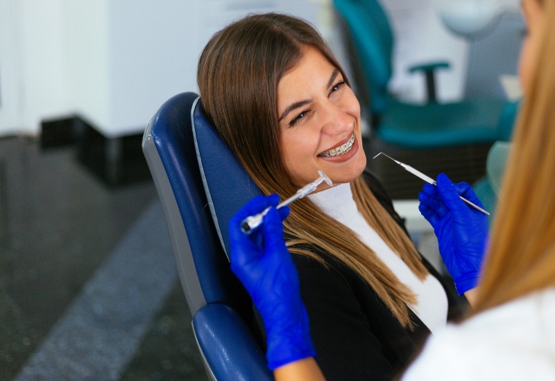 Cosmetic dentist working on braces in Livonia, MI