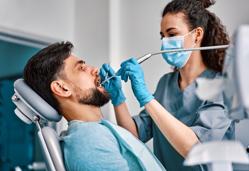 Dentist placing implants in Livonia, MI