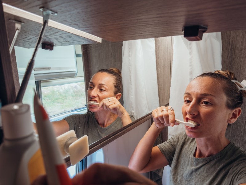 Person brushing teeth at home for daily oral health routine in Livonia, MI
